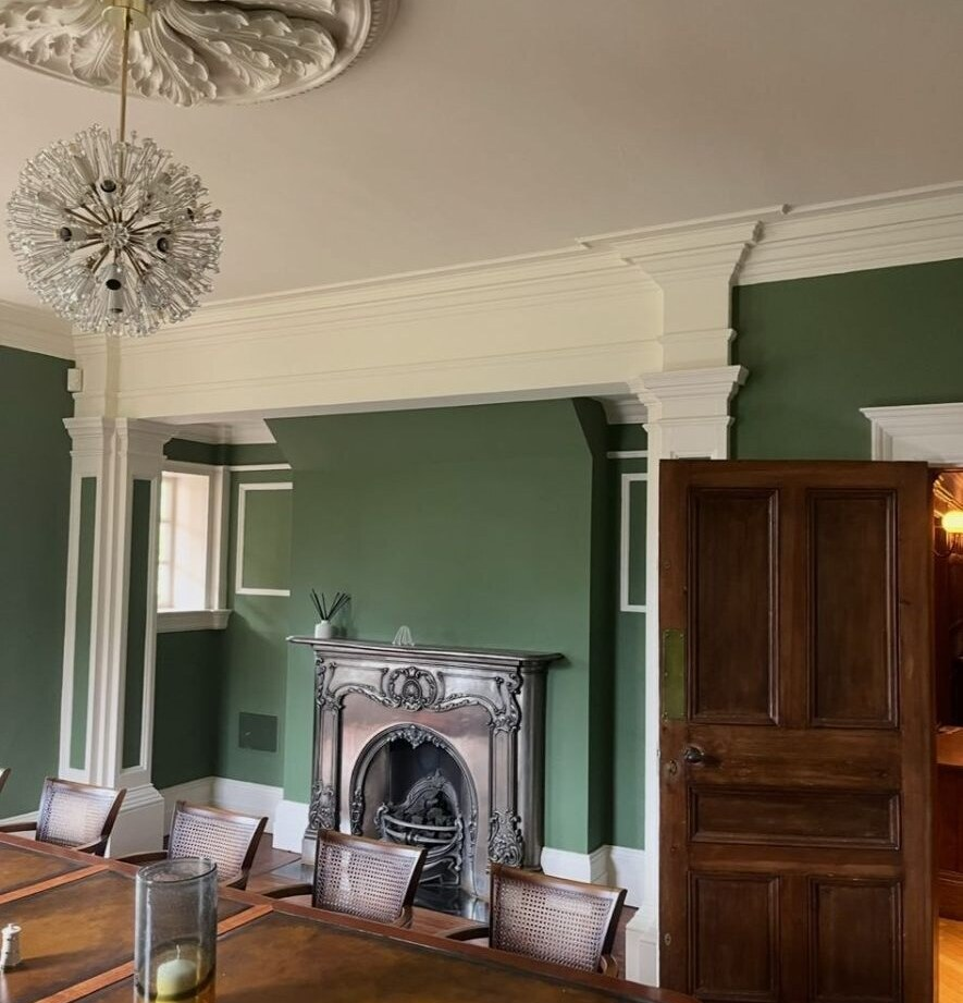 Hand-painted green dining room with ornate plaster ceiling rose and crisp white cornicing